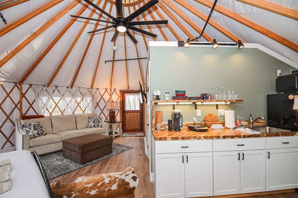 Step outside to your private outdoor oasis featuring a cozy deck, grill, and shaded seating area. Relax by the fire pit with free firewood provided. This peaceful retreat offers the perfect blend of comfort and adventure.