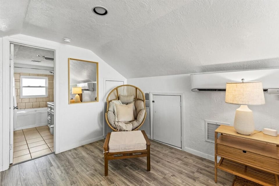Find a moment of peace in this cozy reading nook, a delightful spot to unwind with a book and ocean views.