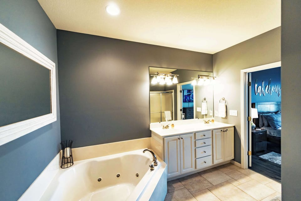 The master ensuite offers a double vanity, shower, & jetted soaking tub