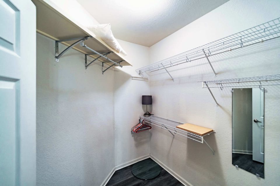 Keep clothes & bags neatly tucked away in the master suite closet