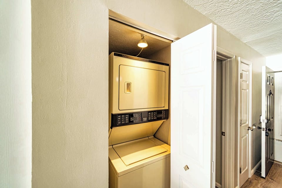 Private laundry is enclosed in the closet adjacent to the kitchen