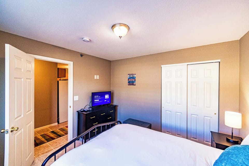 The second bedroom offers a queen bed & Smart TV.
