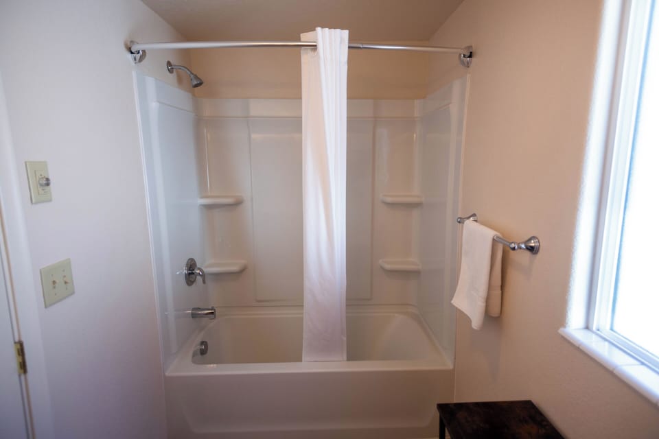 Single Room, 1 King Bed, Non Smoking | Bathroom | Combined shower/tub, hair dryer, towels, soap