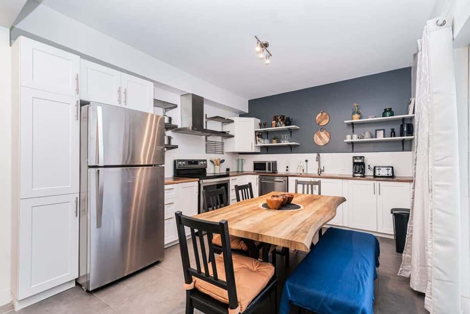 Warm wood dining area paired with sleek white countertops, blending natural charm with modern style.
