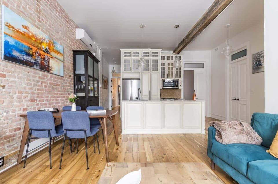 Open-concept view from the living area to the dining and kitchen spaces, creating a seamless, airy flow perfect for gatherings and connection.