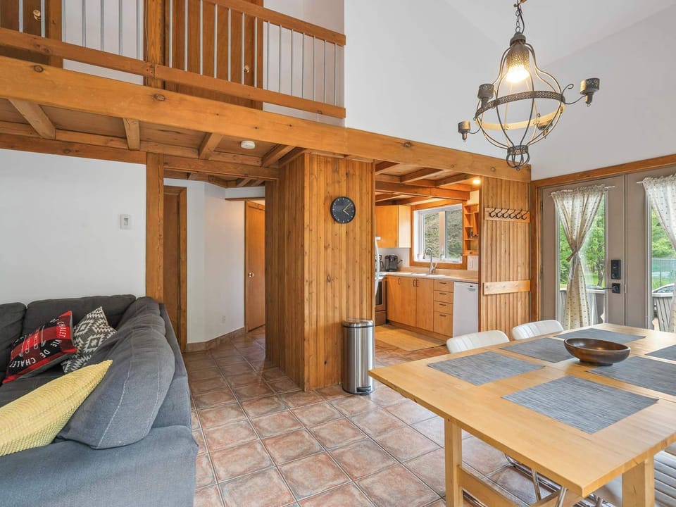 Open-concept living and dining area with warm wood accents