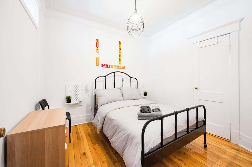 Well-appointed bedroom with warm wood floors and a calm, relaxing ambiance.