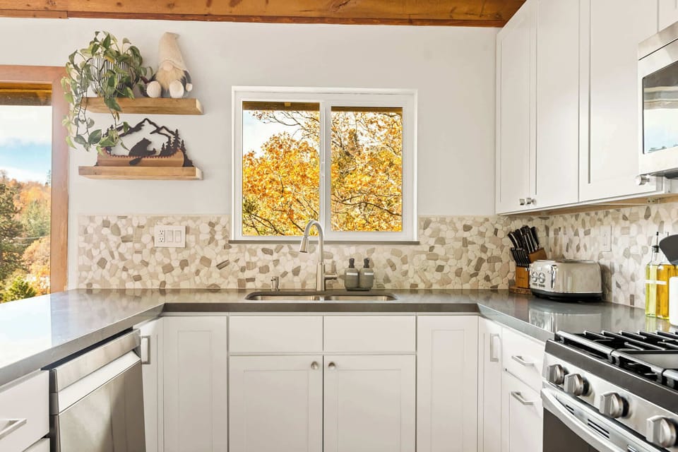 The chic, updated kitchen offers ample counter space to prepare a delicious meal.