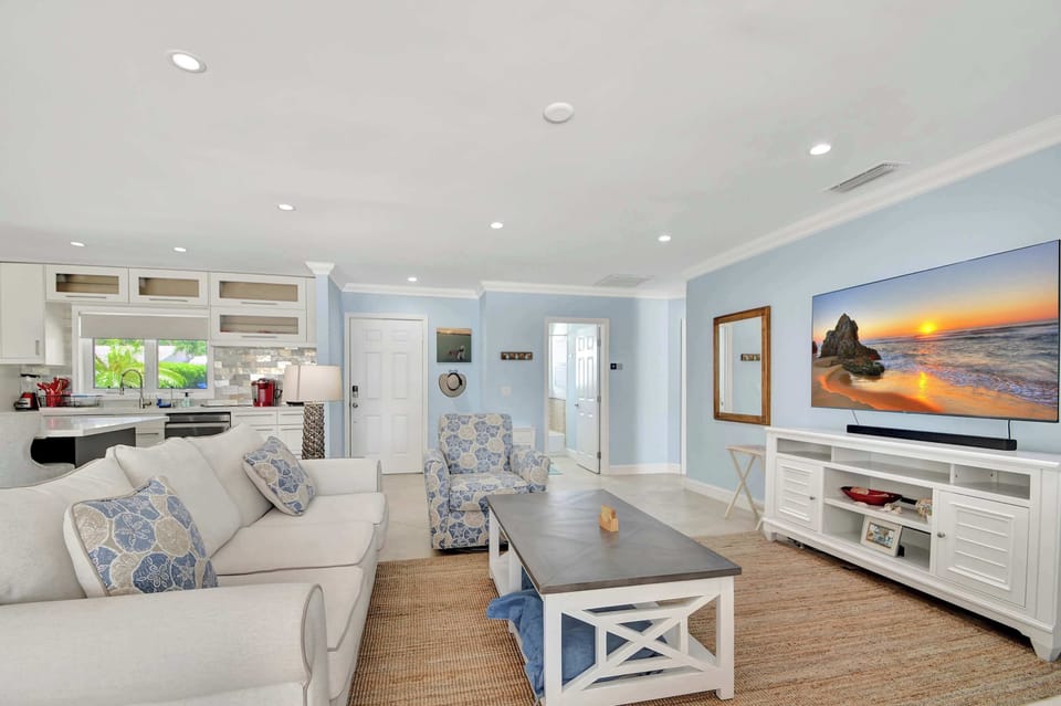 Bright open living space with comfy seating and Smart TV