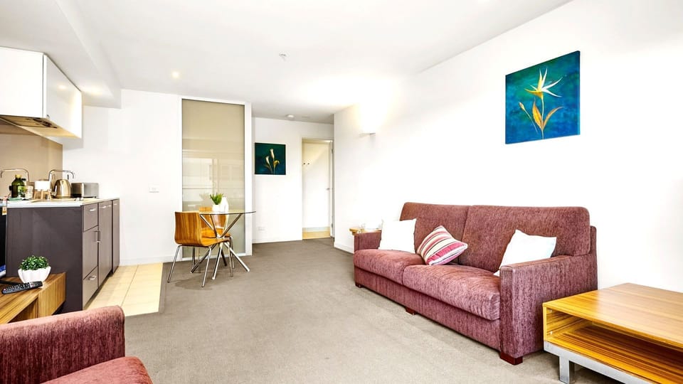 Wide-angle view showing the effortless connection from kitchen to relaxed seating.