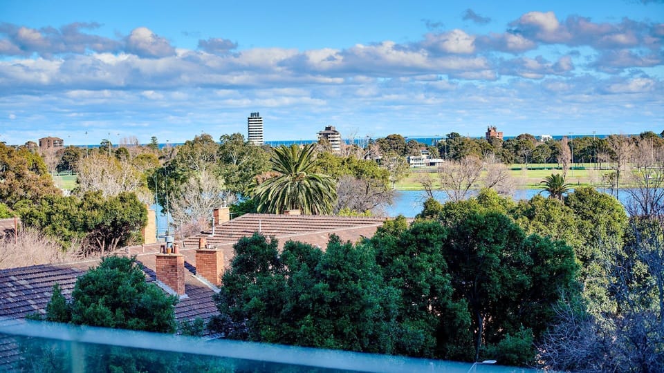 Breathtaking, expansive green vistas overlooking the scenic lake and distant skyline.