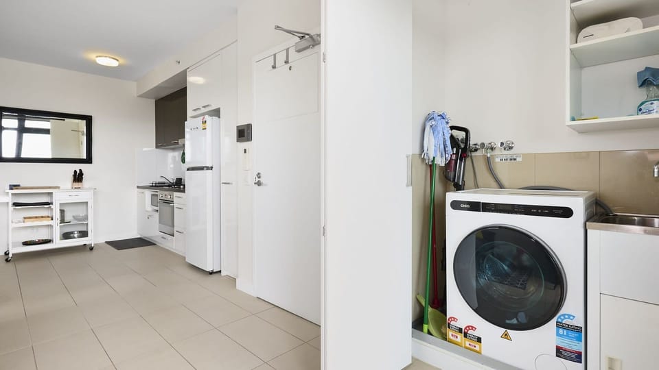 Smartly designed laundry and utility space with built-in storage for easy apartment living.