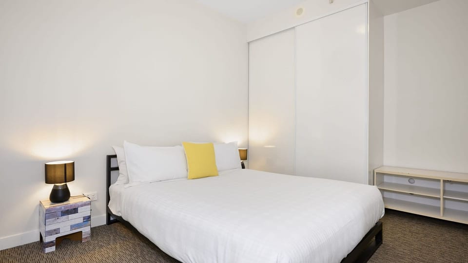 Cozy bedroom sanctuary with soft natural light, plush comfort, and a calming neutral palette.