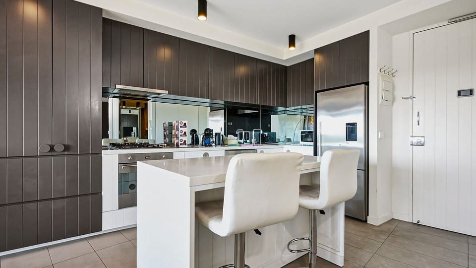 High-end finishes, ample storage, and top-tier appliances make this kitchen a home chef’s dream.