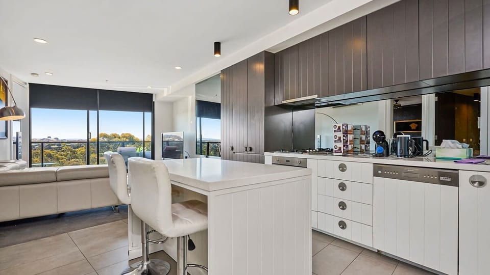 Cook in style with premium cabinetry, modern appliances, and a chic breakfast bar for casual dining.