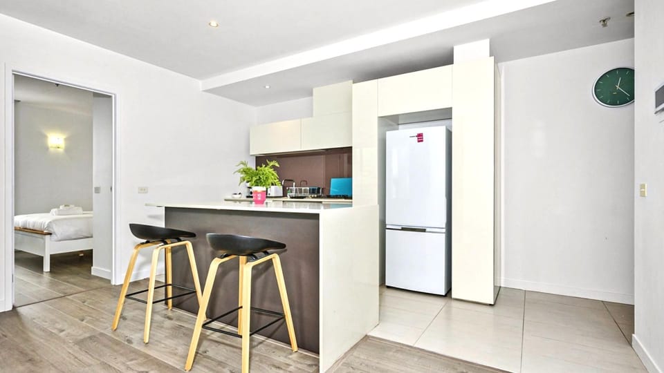A sleek breakfast bar setup that’s built for morning coffee and late-night snacks.