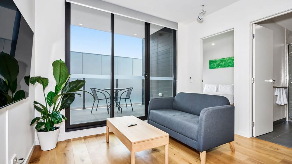 Cozy lounge space with floor-to-ceiling windows and stylish minimalist interiors.
