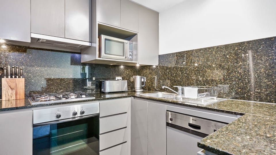 Sleek gourmet kitchen with polished stone finishes and quality appliances.