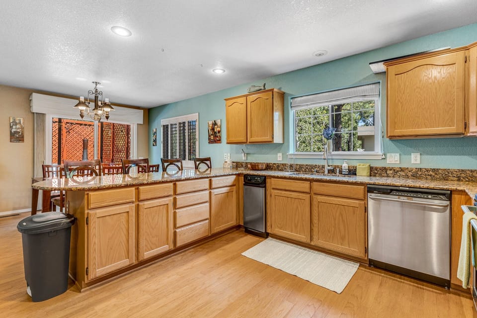 The fully equipped kitchen is perfect for preparing meals for your group, featuring granite countertops, stainless steel appliances, and ample storage.