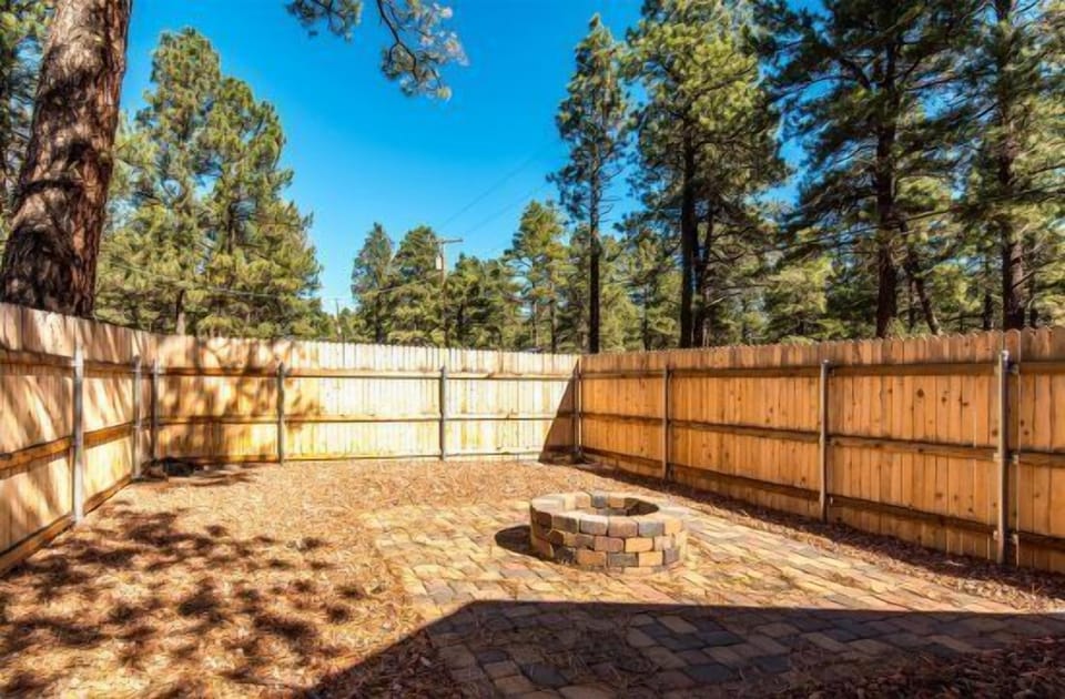 Private Fenced Backyard: Includes a fire pit, seating area, and space for your furry friend to roam.