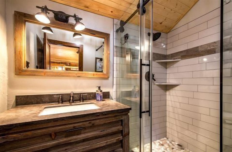 Remodeled Bathroom: Features a spacious tiled shower, modern vanity, and excellent water pressure for a spa-like experience.