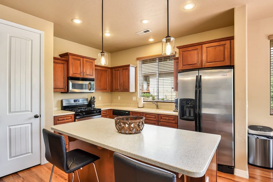 Stocked with stainless steel appliances, stone countertops, and everything you need to cook up a feast!