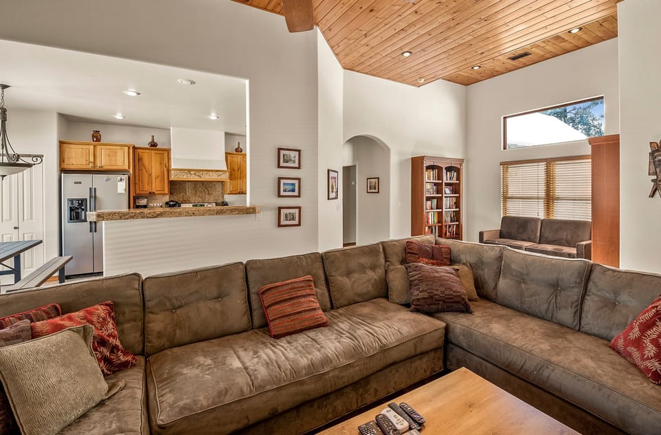 The open-concept layout is designed for relaxation, with a large L-shaped sectional couch perfect for watching TV or digging into a great book from the home's mini-library in a cozy nook equipped with sleeper-sofa.