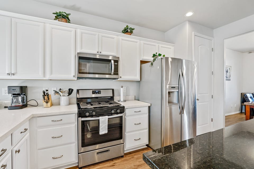 The kitchen is spacious and modern, holding stainless steel appliances, a traditional coffee machine and a slow cooker for your convenience