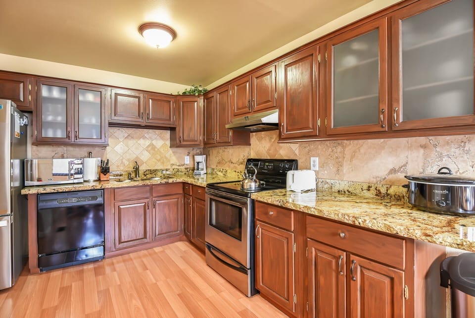 Cook up a storm in the fully equipped kitchen featuring granite countertops and modern appliances.