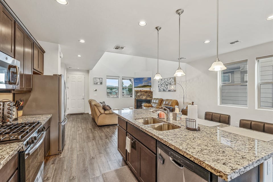 double sink, a dishwasher, and four slice toaster, kettle, Keurig, dark cabinetry and granite countertops