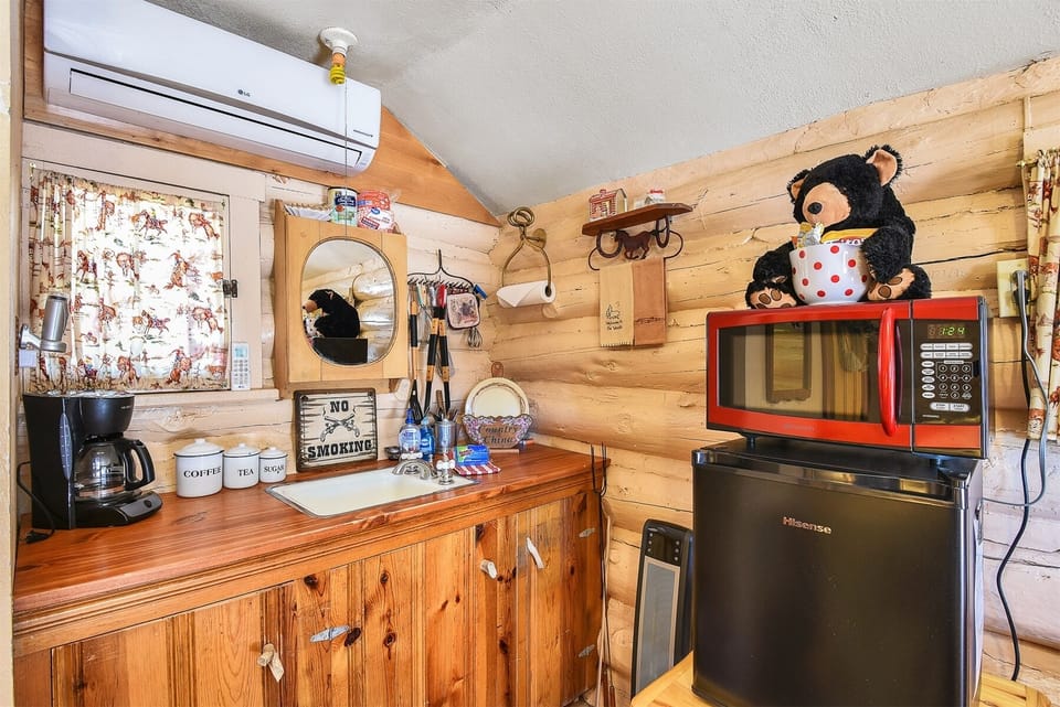 All the comforts of home in this cozy cabin, featuring a mini fridge, coffeemaker, and microwave for your convenience.
