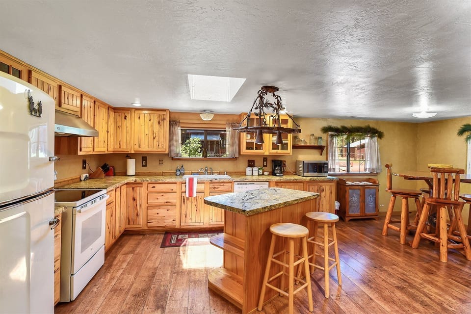 Gather around the cozy log table for a meal, or sit at the kitchen island, which seats two.