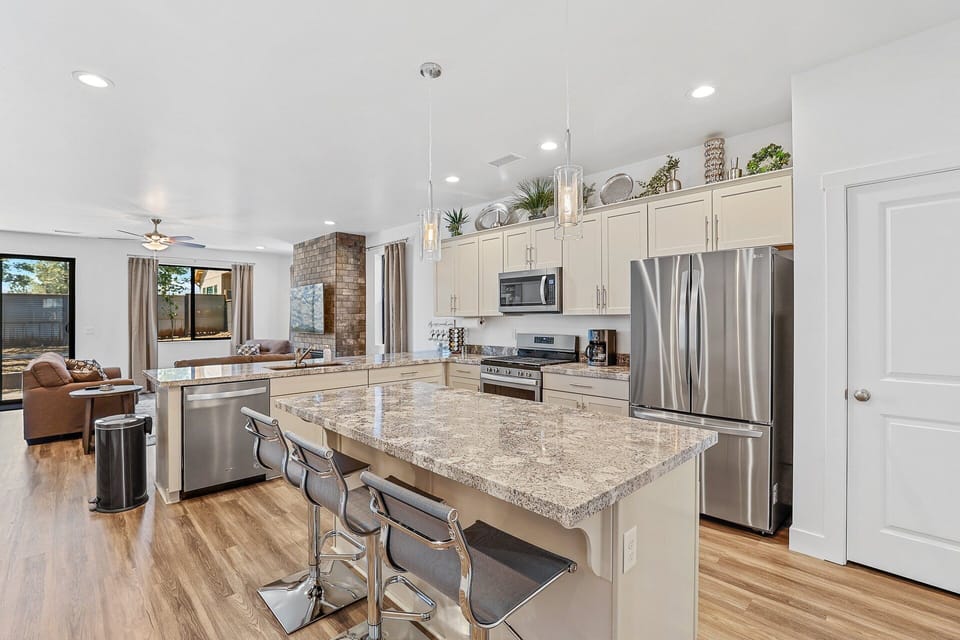Gather around the spacious kitchen counter in this modern kitchen, where style meets functionality for the ultimate cooking experience.