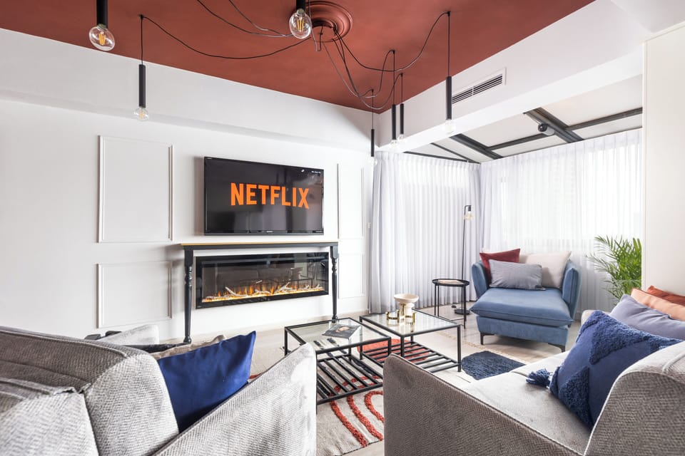 Deluxe Apartment, City View | Living area | 65-inch LED TV with satellite channels, fireplace, tablet
