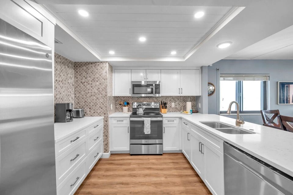 Another kitchen angle highlighting the open layout & easy connection to the living area.