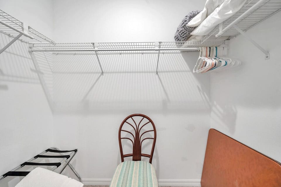 Walk-in closet w/ built-in shelving and hanging space to stay neatly organized.