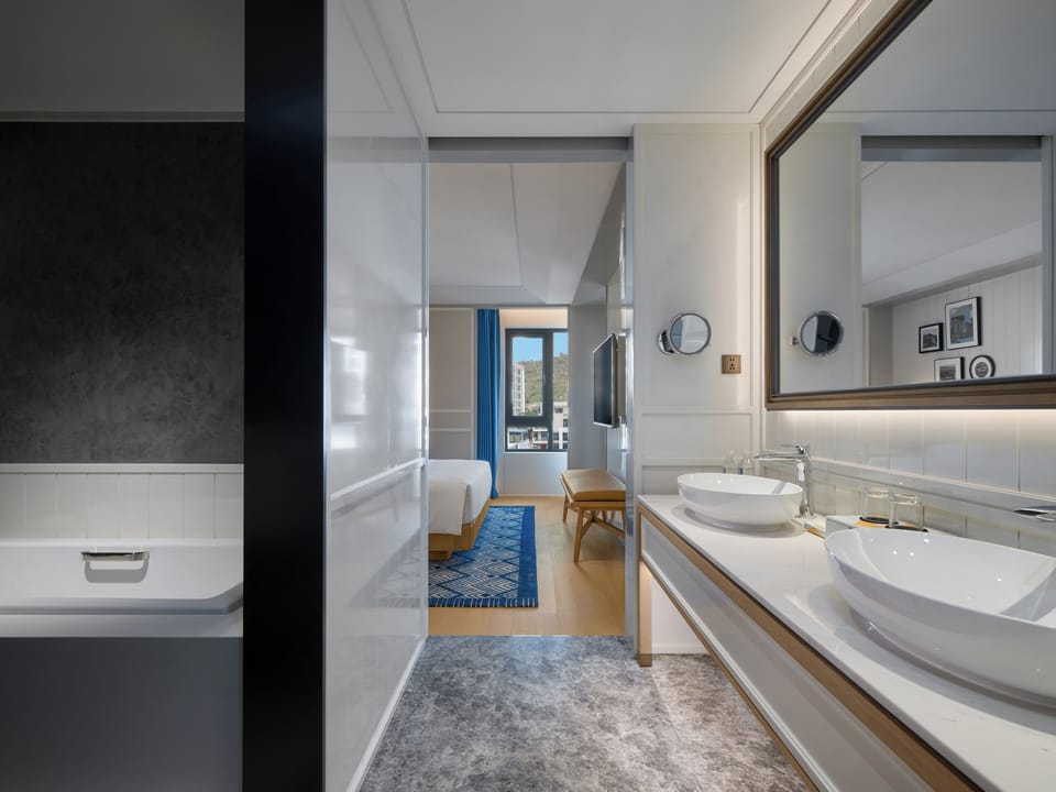 Suite, 1 King Bed (Centric) | Bathroom | Hair dryer, bathrobes, slippers, towels