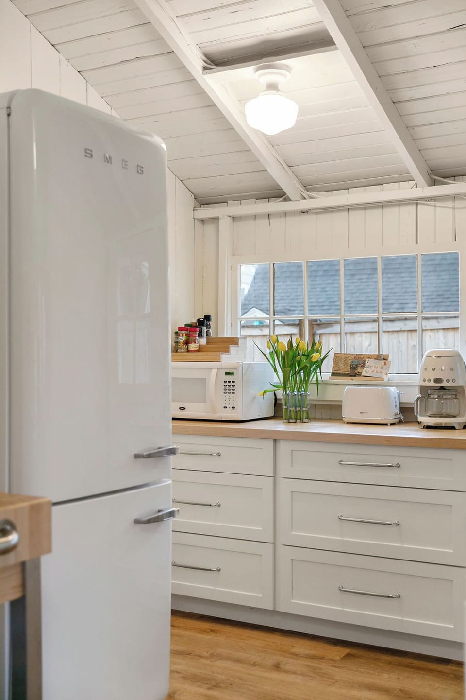 Close up view of Smeg fridge, microwave, toaster, and coffee maker