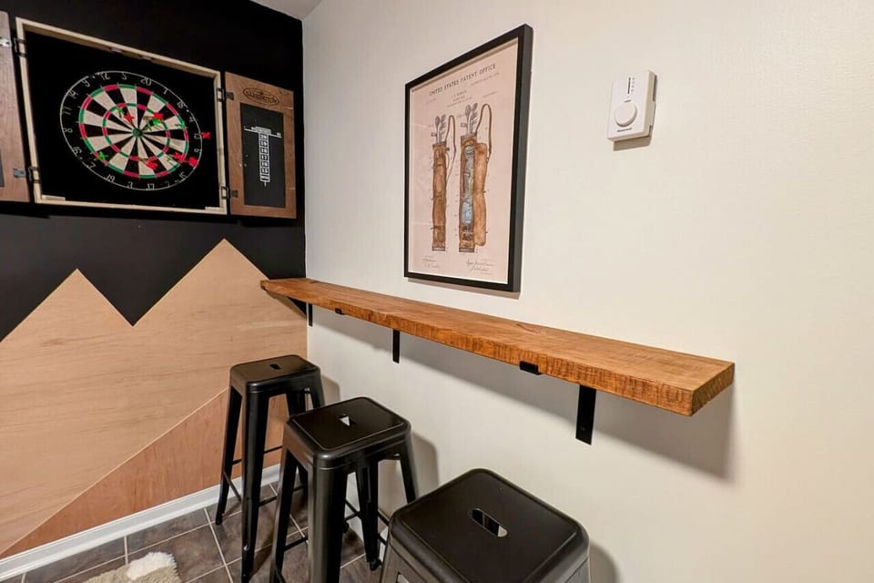 Game room with foosball, arcade games, darts, basketball, smart TV and small bar