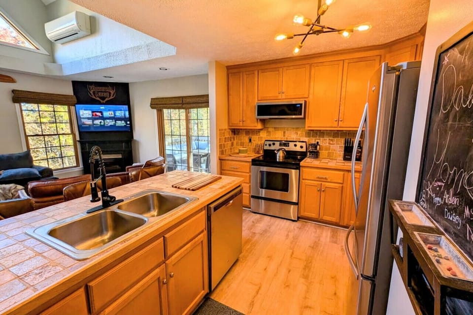 Fully stocked kitchen including crock pot, Keurig and coffee pot stocked with coffee pods, sugar, and creamer