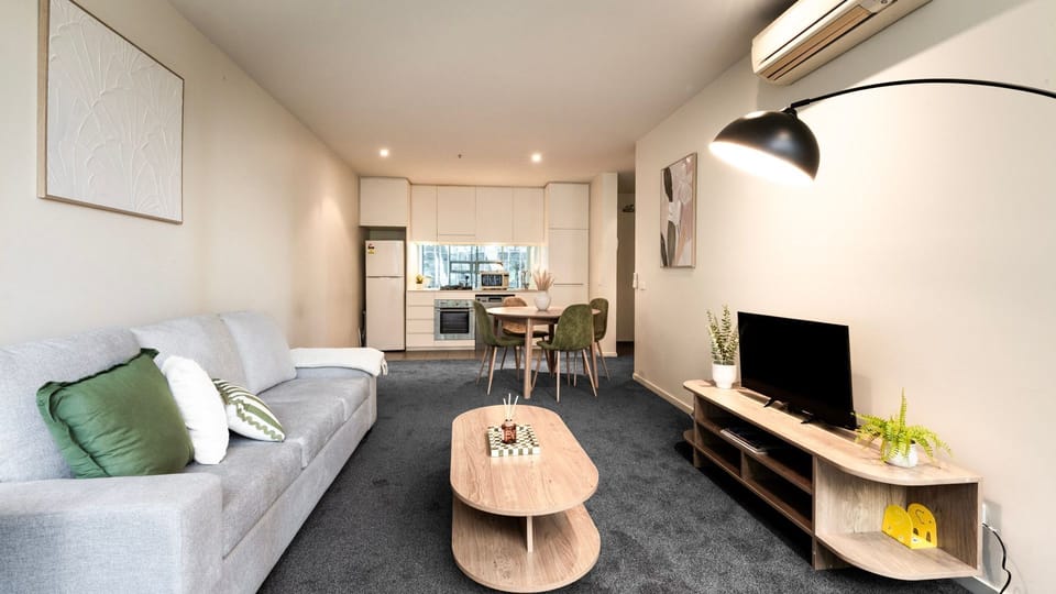 This comprehensive view highlights the apartment's seamless flow from the kitchen and dining area to the living room.