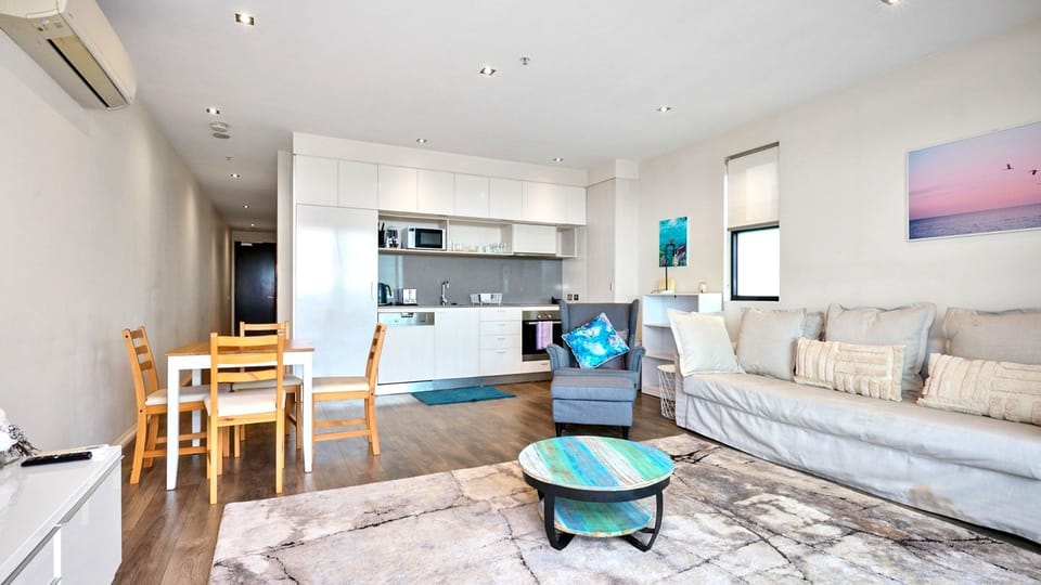 A seamless blend of dining and lounging areas, accented with cool blues and warm timber tones