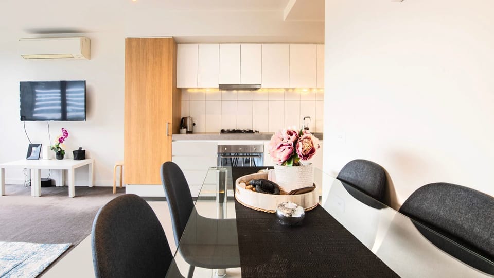 Elegant dining space flowing seamlessly into a bright and inviting living area.