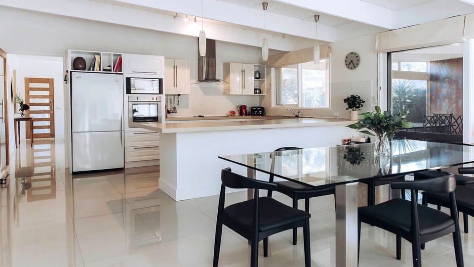 This impressive open floor plan showcases the seamless flow from the dining area straight into the spacious kitchen.