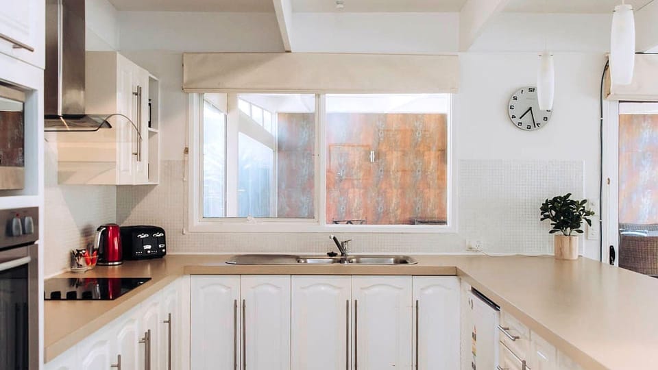 A bright window over the double kitchen sink fills the entire culinary space with refreshing natural light.