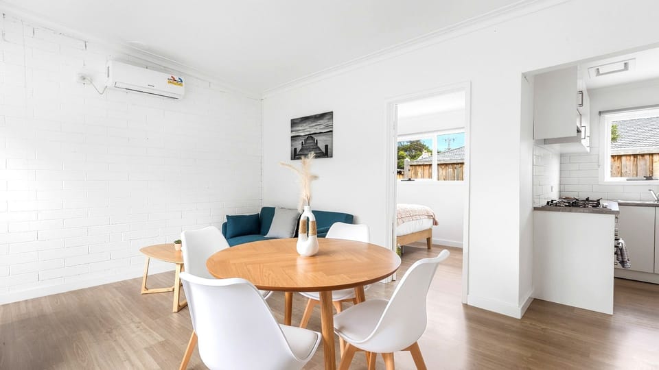 Gather around the dining table for meals and good conversation in this bright, spacious setting.
