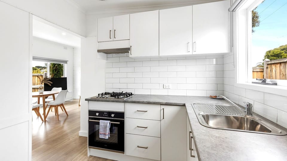 A crisp, contemporary kitchen with generous cabinetry, quality appliances and everything you need for a comfortable stay.