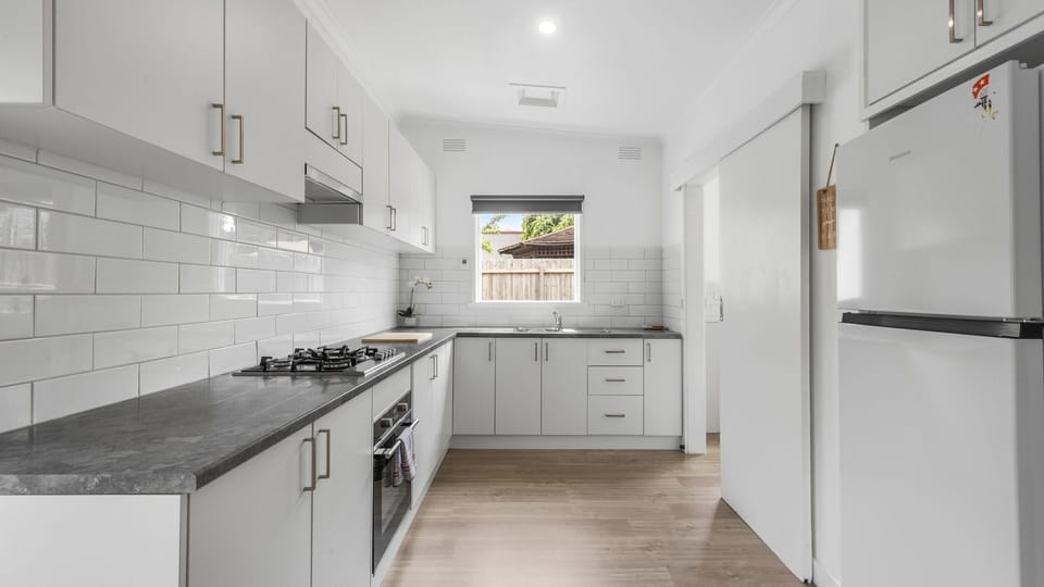 Cook with ease in the sleek kitchen, complete with ample storage, modern appliances and plenty of bench space.