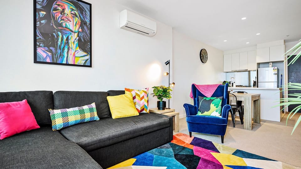 Vibrant open-plan living area styled with modern furnishings and bold colour accents.