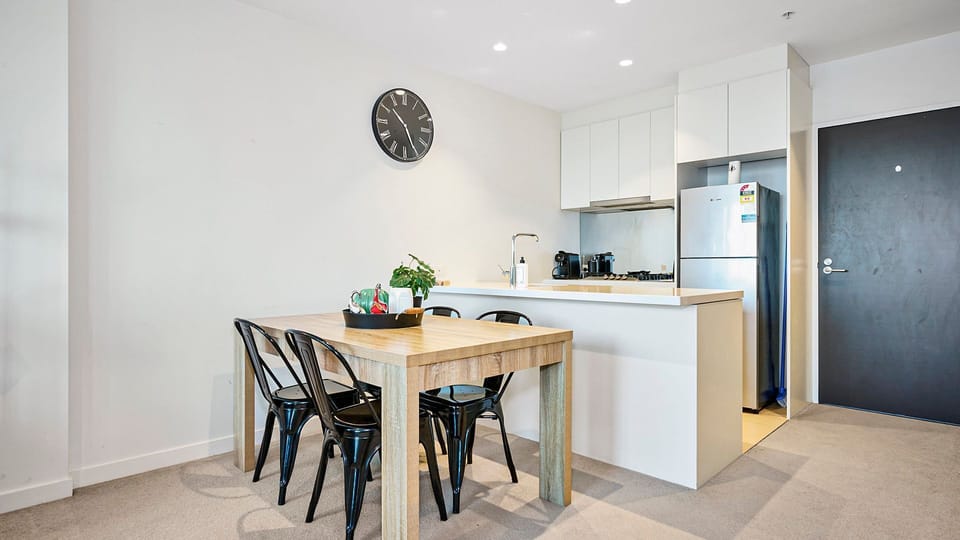 Bright contemporary dining and kitchen space with clean finishes and functional layout.